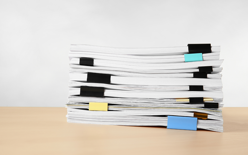 A organized stack of audited business files and tax documents.